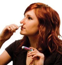 Woman Using Olbas Inhaler
